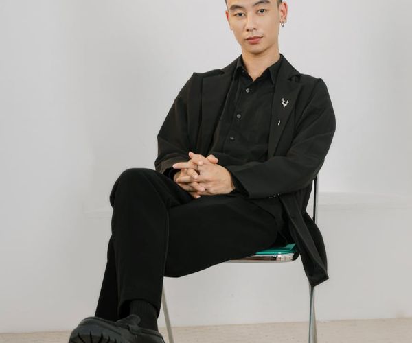 Man looking confidently forward after a workout session with a calm background.